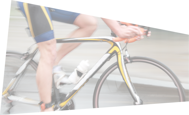 Side view of a very rapid professional male cyclist without torso dressed in a blue sport suit. Motion blur