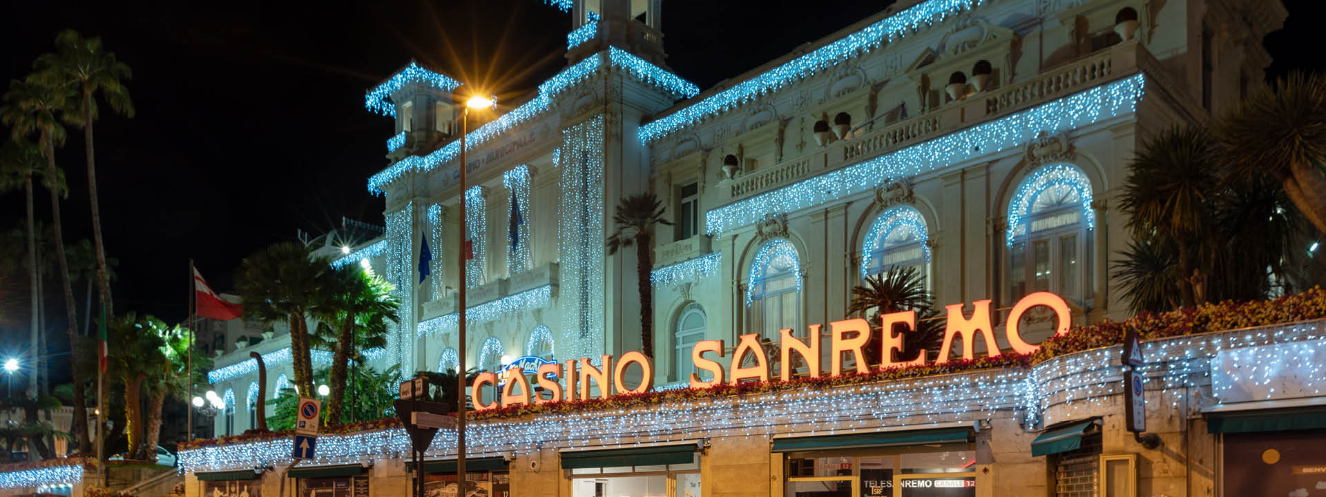 Sanremo, Italy - March 19, 2019: Facade view by night of the Municipal Casino in Sanremo, built in 1905, is an example of liberty style building