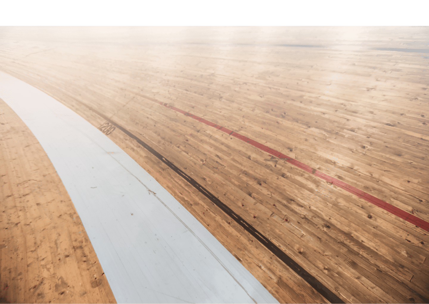 wooden track surface for an indoor velodrome venue for cycling. This oval track is used for indoor cycling competitions and events.